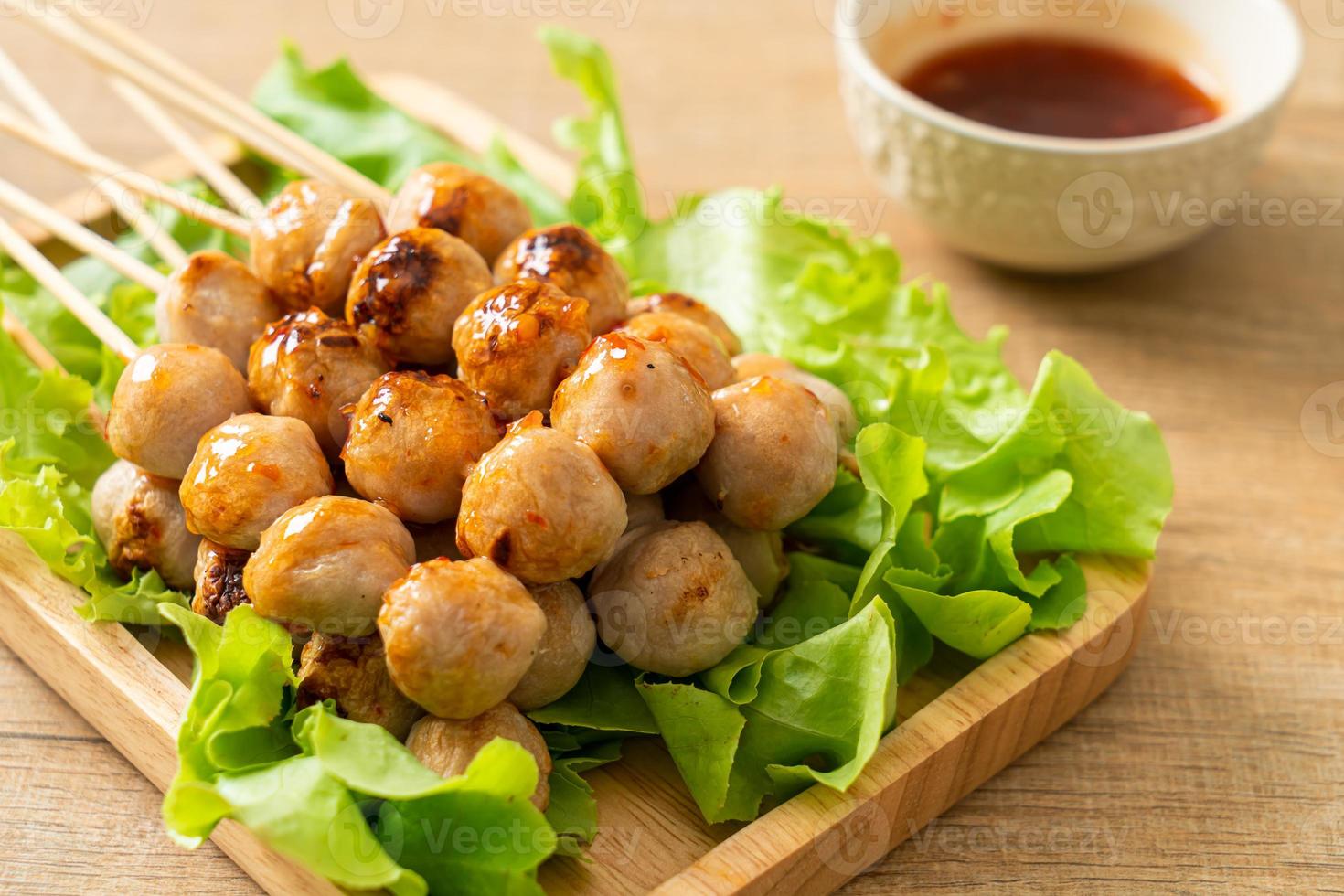 Grilled meatballs skewer with spicy dipping sauce photo