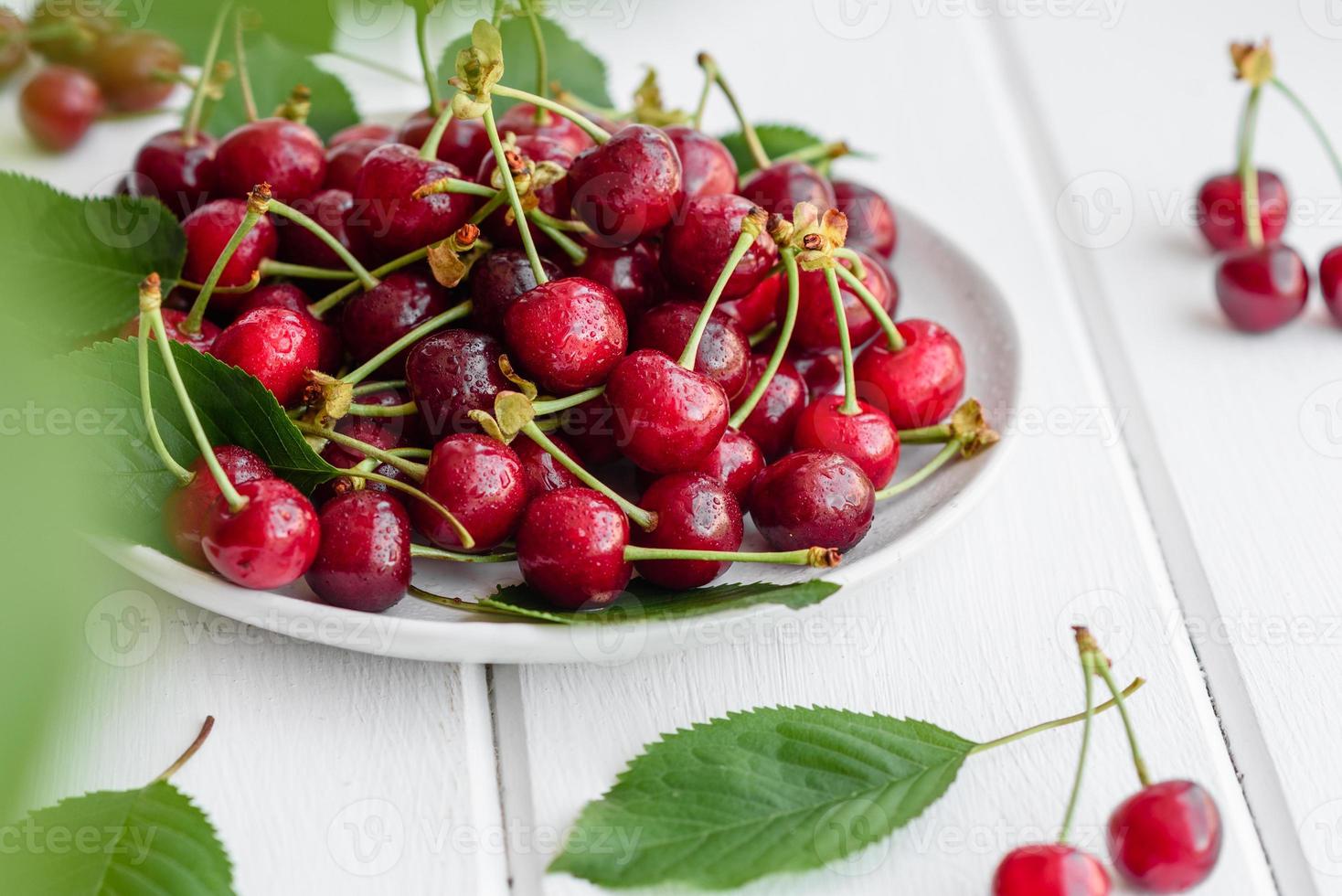 Fresh delicious red bright cherry berries torn in the summer garden photo