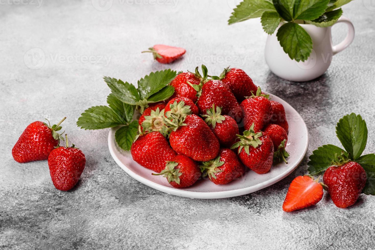 Beautiful juicy fresh strawberries on the concrete surface photo