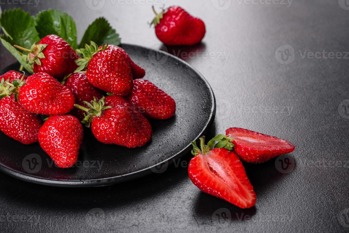 Beautiful juicy fresh strawberries on the concrete surface photo