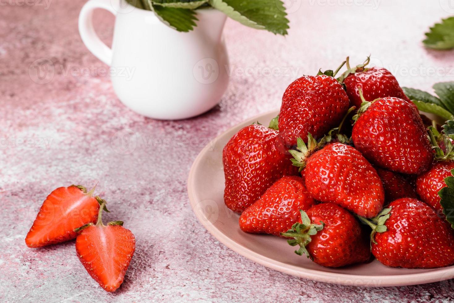 Beautiful juicy fresh strawberries on the concrete surface photo