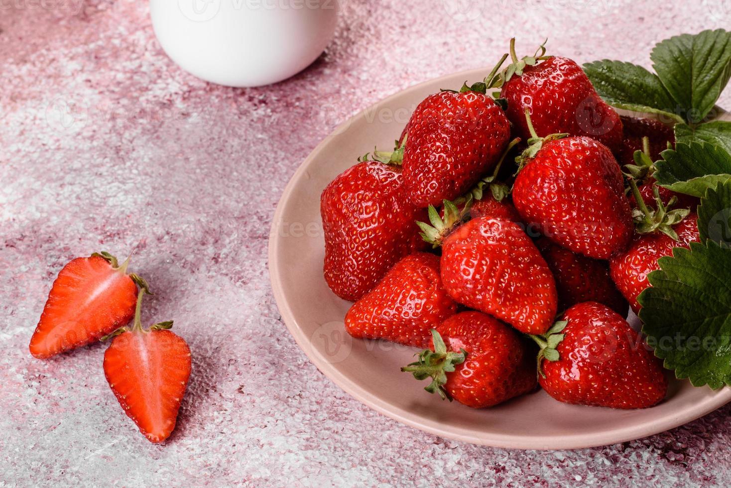 Beautiful juicy fresh strawberries on the concrete surface photo