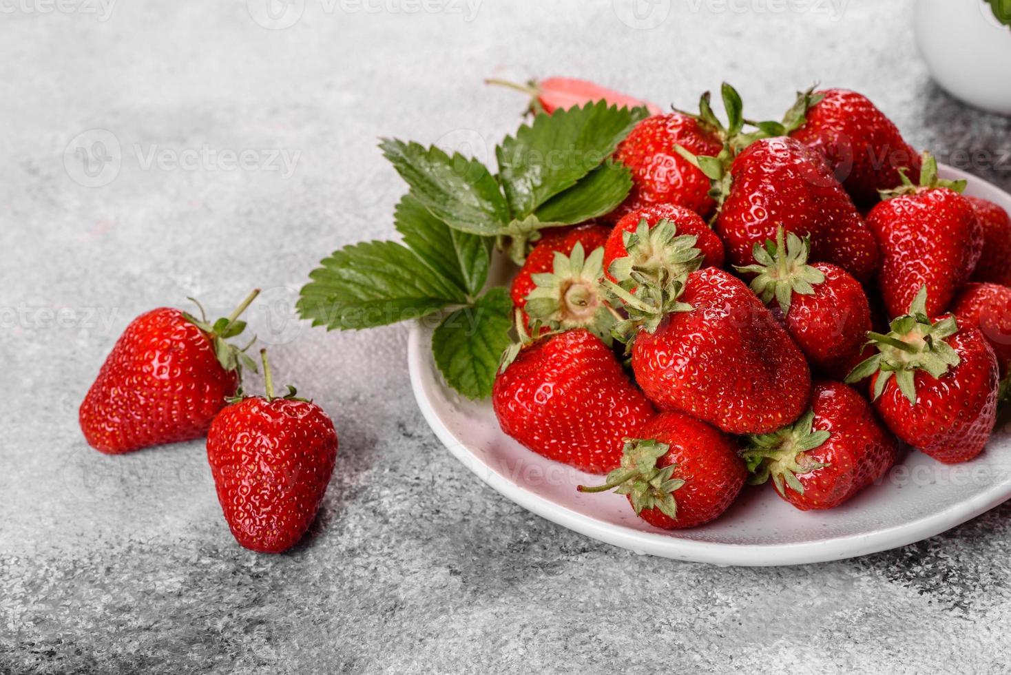 Beautiful juicy fresh strawberries on the concrete surface photo