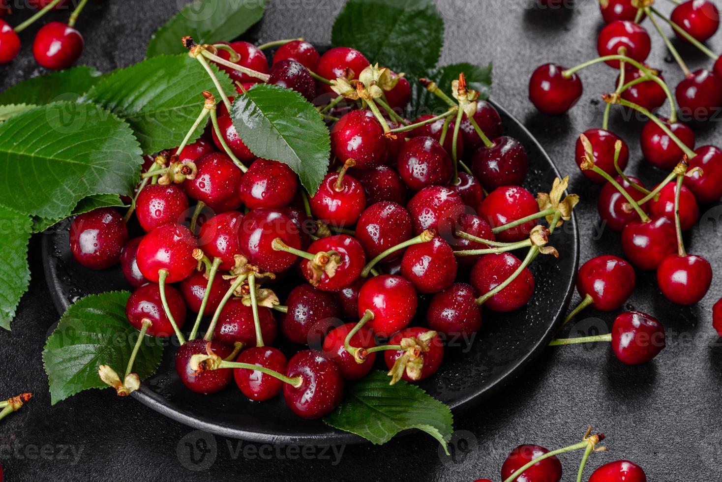 Fresh delicious red bright cherry berries torn in the summer garden photo