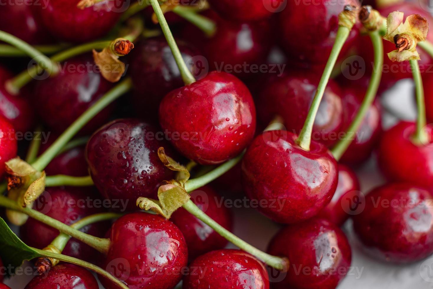 Fresh delicious red bright cherry berries torn in the summer garden photo