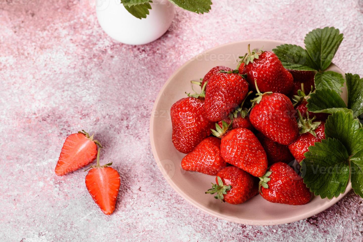 Beautiful juicy fresh strawberries on the concrete surface photo