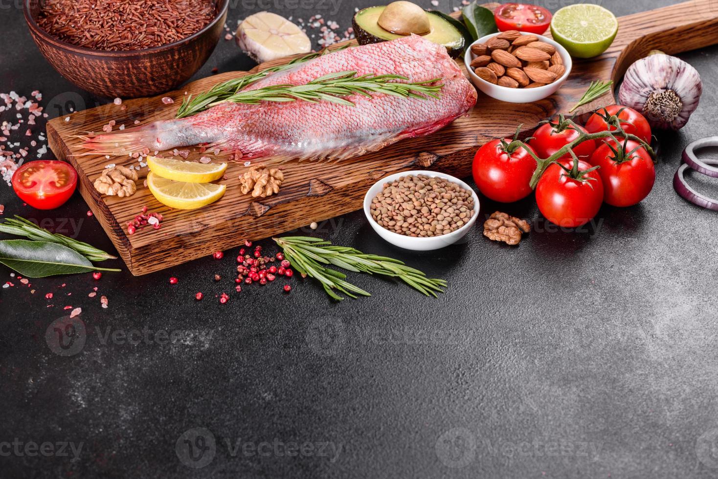 Raw fillet of red sea perch prepared for baking with spices and herbs photo