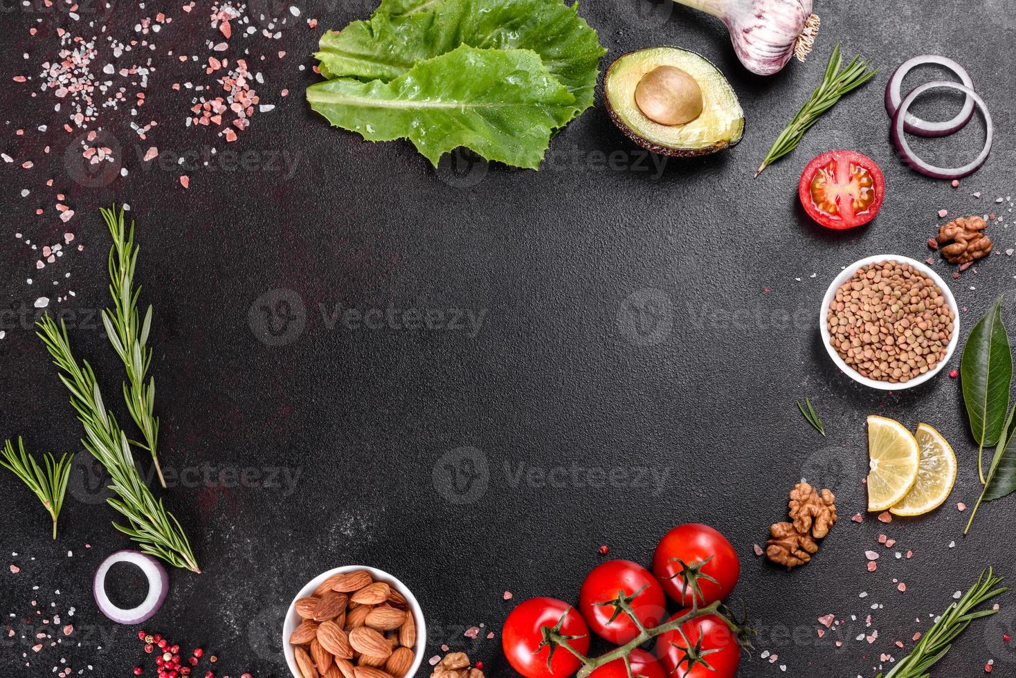 Composition of spices and herbs on a dark concrete background photo