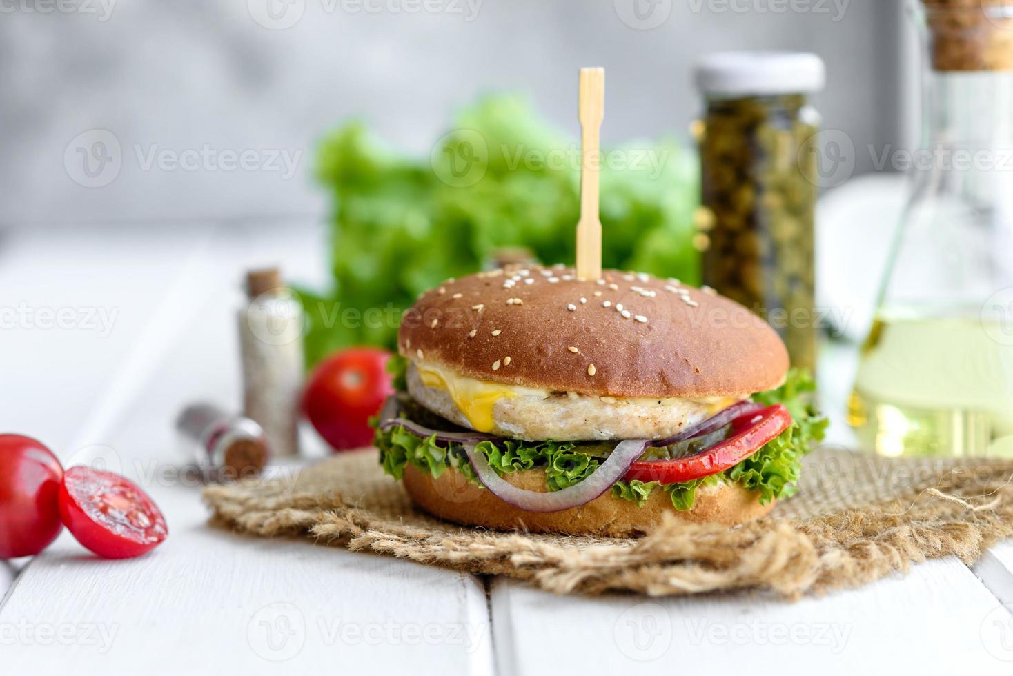 Delicious fresh homemade burger on a wooden table photo