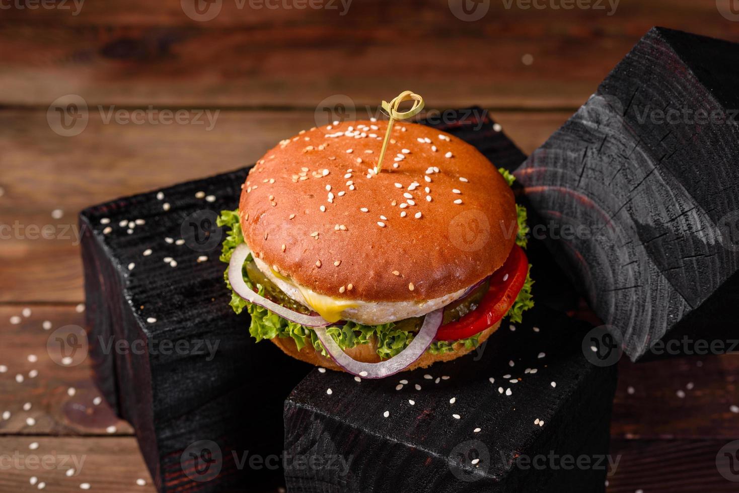 Delicious fresh homemade burger on a wooden table photo