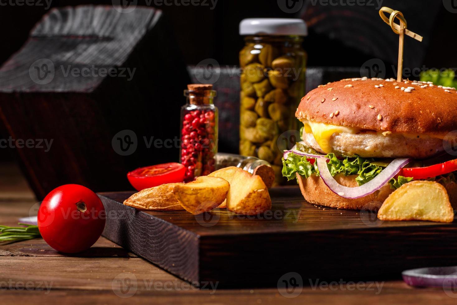 Delicious fresh homemade burger on a wooden table photo