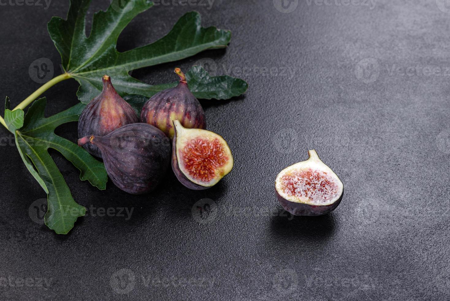 Fresh ripe figs on a dark concrete background. Harvesting figs photo