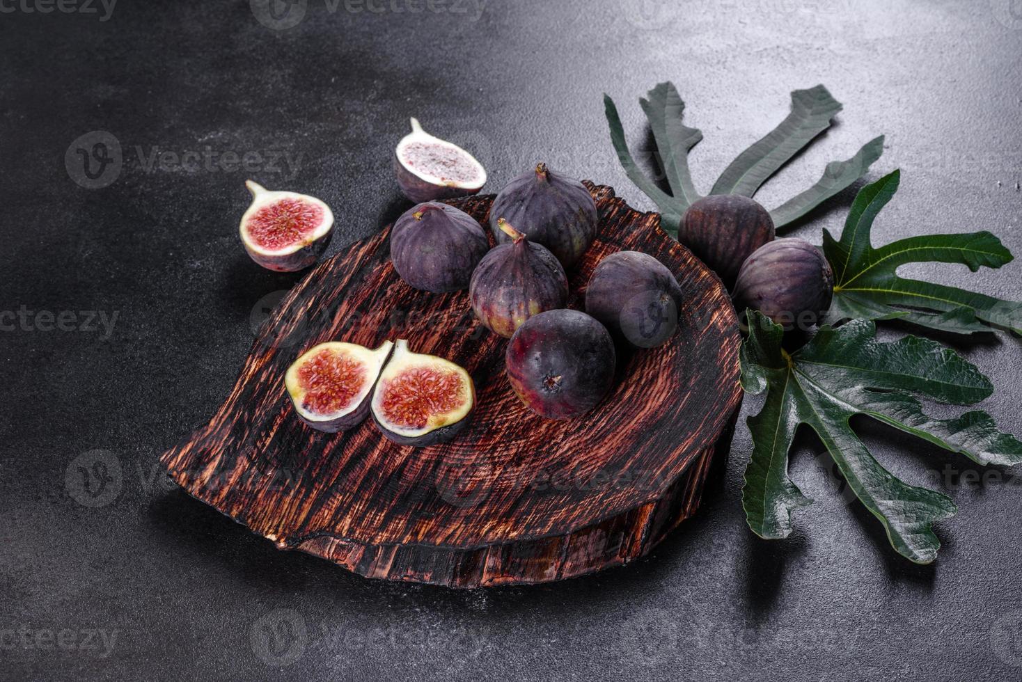 Fresh ripe figs on a dark concrete background. Harvesting figs photo