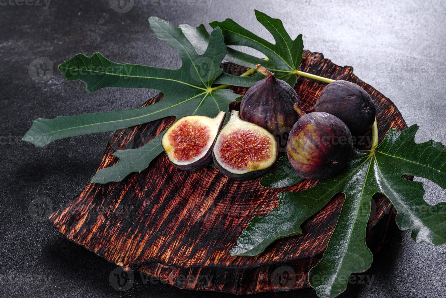 Fresh ripe figs on a dark concrete background. Harvesting figs photo