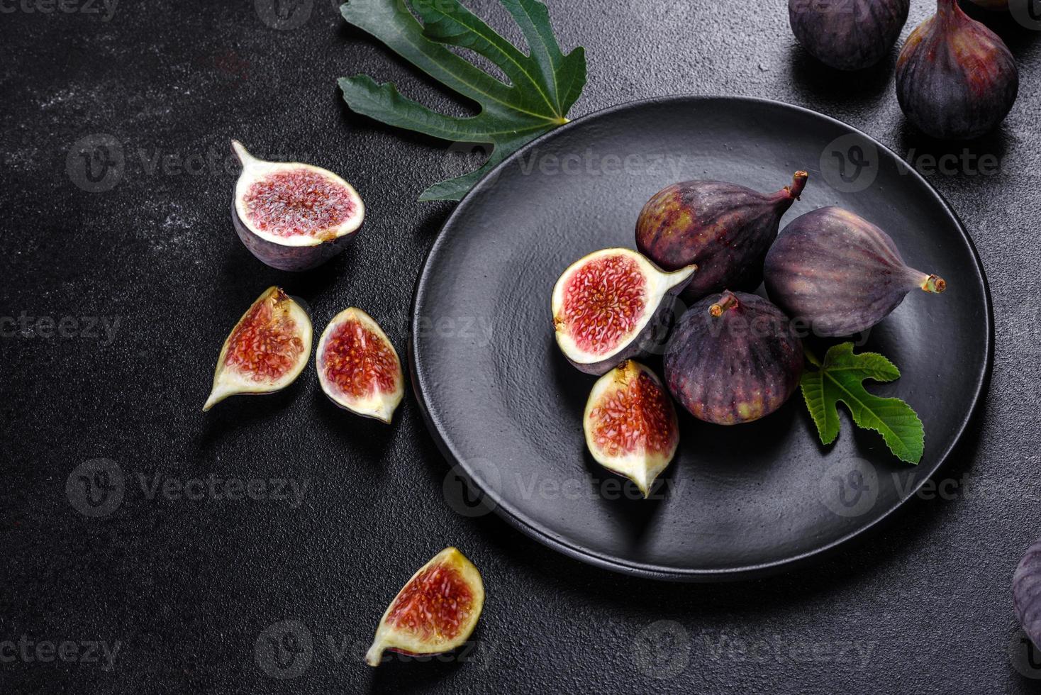 Fresh ripe figs on a dark concrete background. Harvesting figs photo