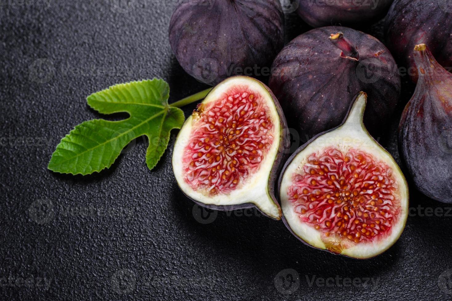 Fresh ripe figs on a dark concrete background. Harvesting figs photo