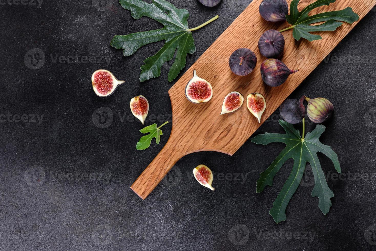 Fresh ripe figs on a dark concrete background. Harvesting figs photo