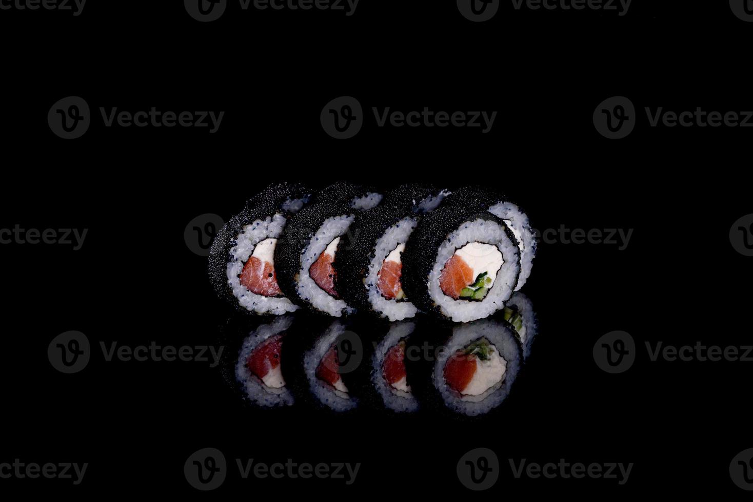 Rollos de sushi hermosos y deliciosos frescos sobre un fondo oscuro foto