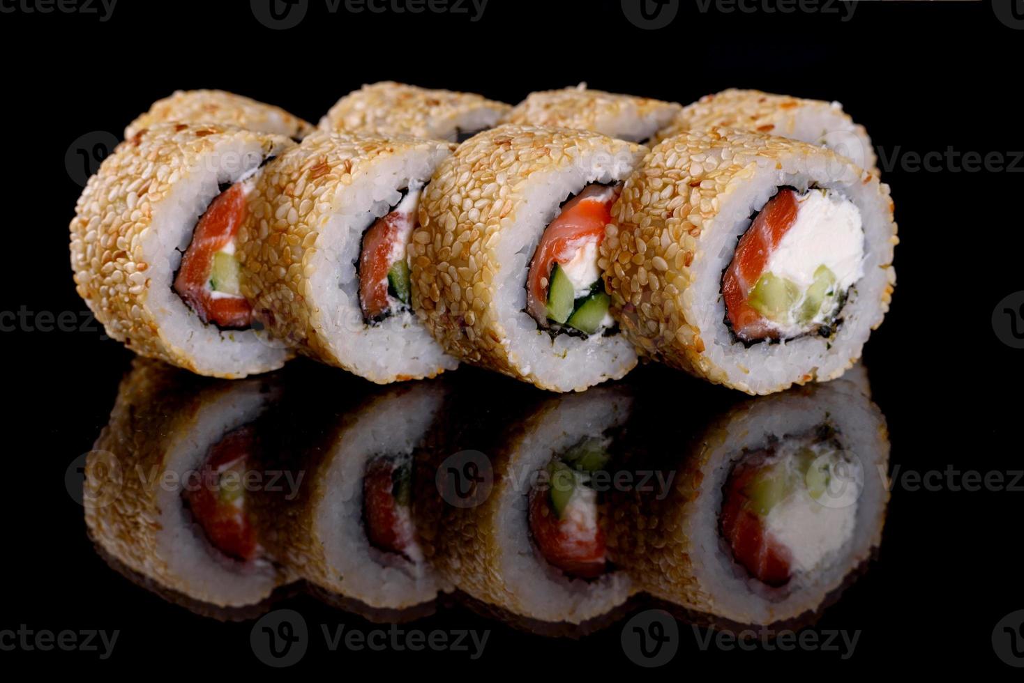 Fresh delicious beautiful sushi rolls on a dark background photo