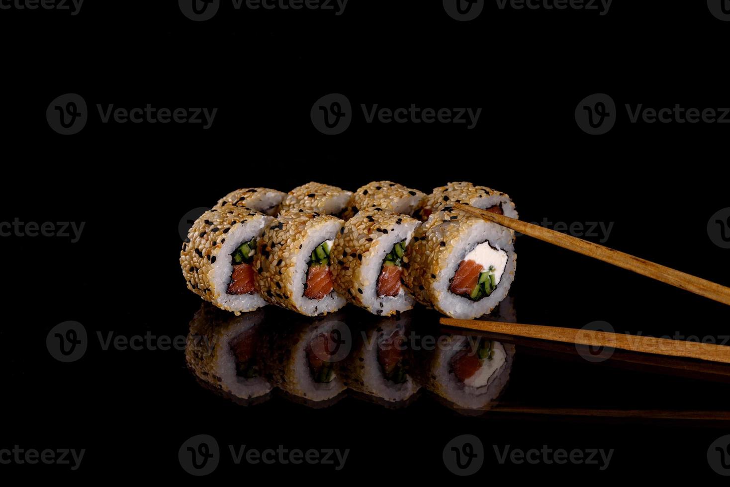 Fresh delicious beautiful sushi rolls on a dark background photo