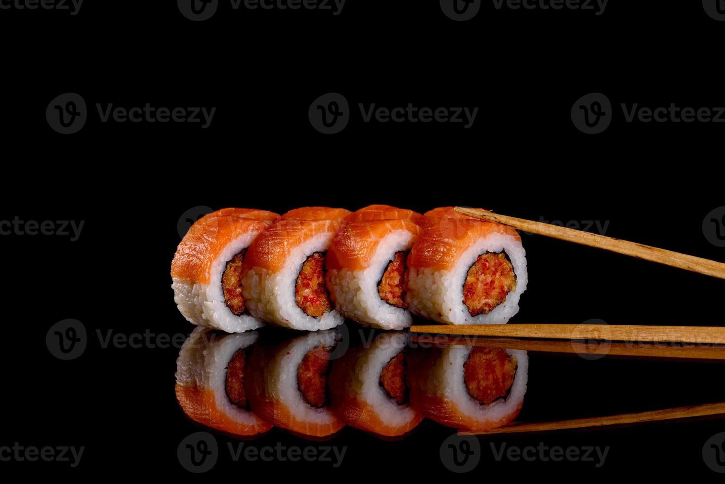 Fresh delicious beautiful sushi rolls on a dark background photo