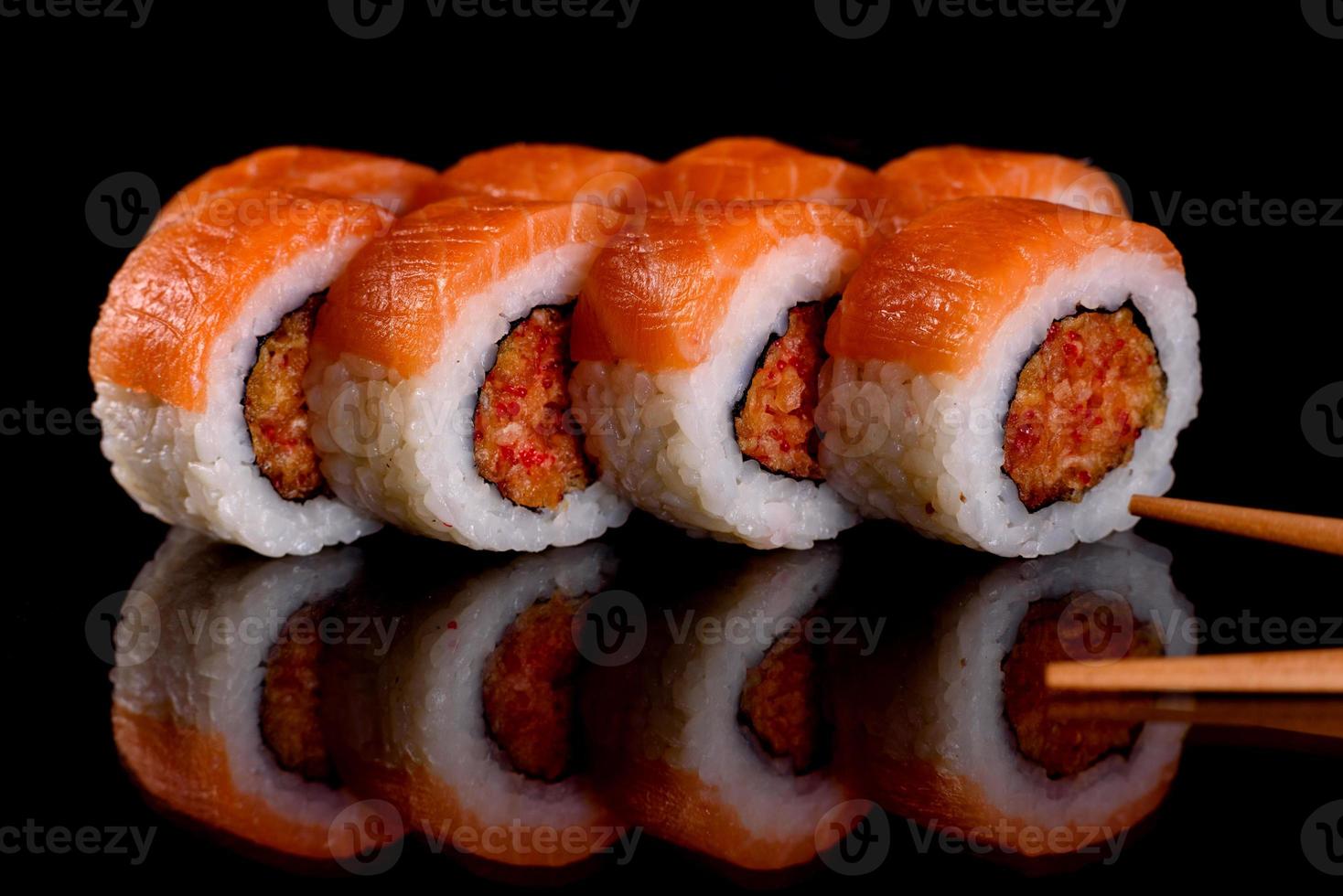 Fresh delicious beautiful sushi rolls on a dark background photo