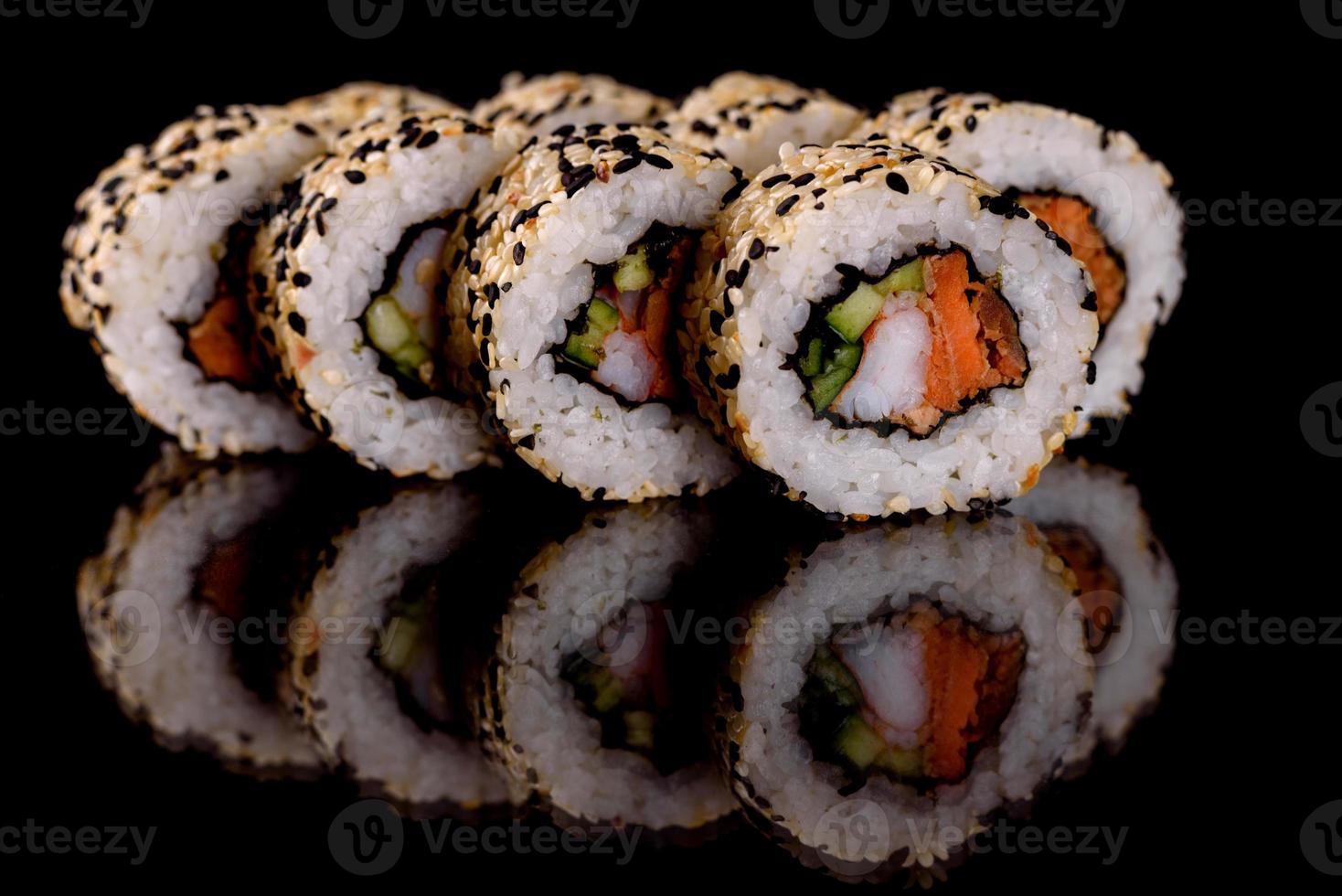 Fresh delicious beautiful sushi rolls on a dark background photo