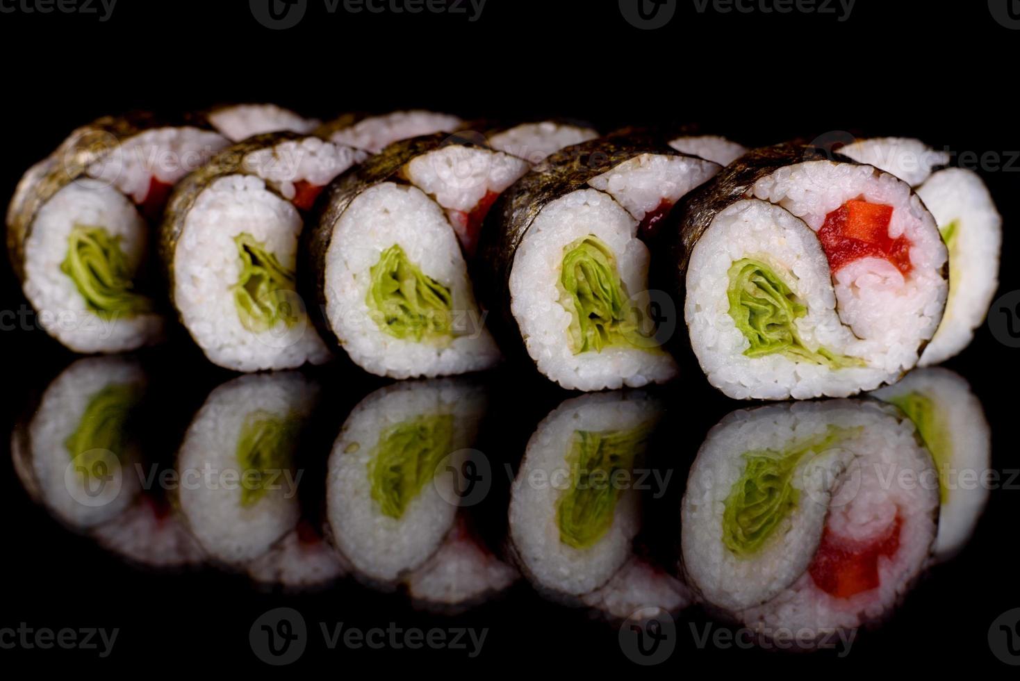 Fresh delicious beautiful sushi rolls on a dark background photo