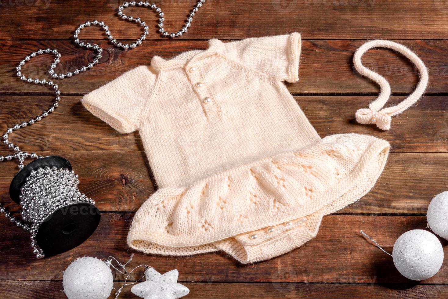 Children's knitted clothes are white in natural wool photo