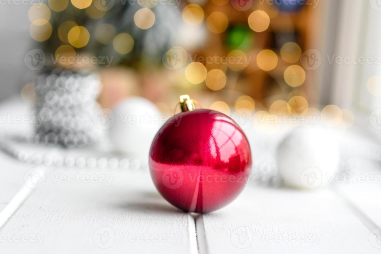 Beautiful multi-colored Christmas decorations on a light wooden table photo