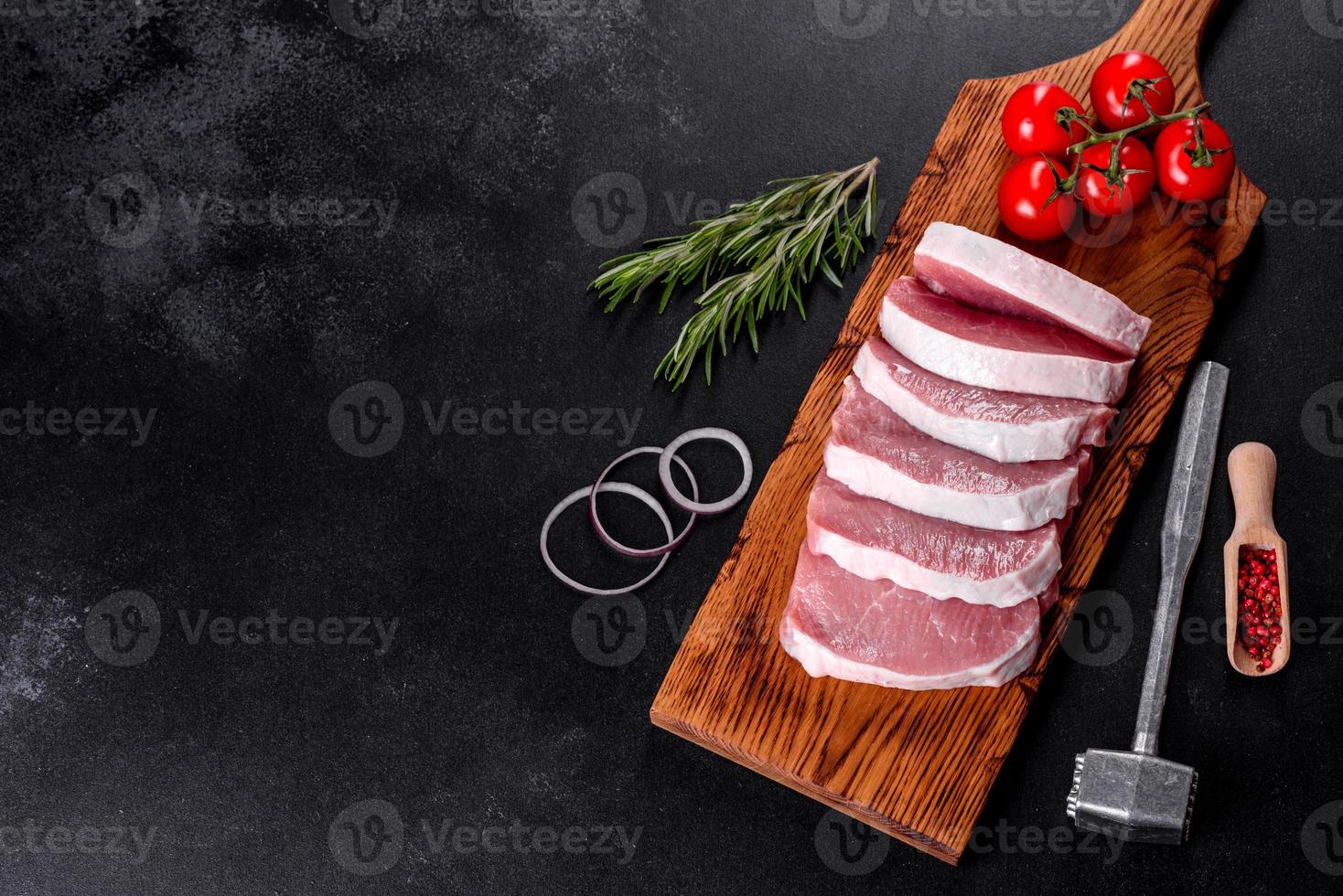 A fresh raw piece of pork escalop cut into several parts photo