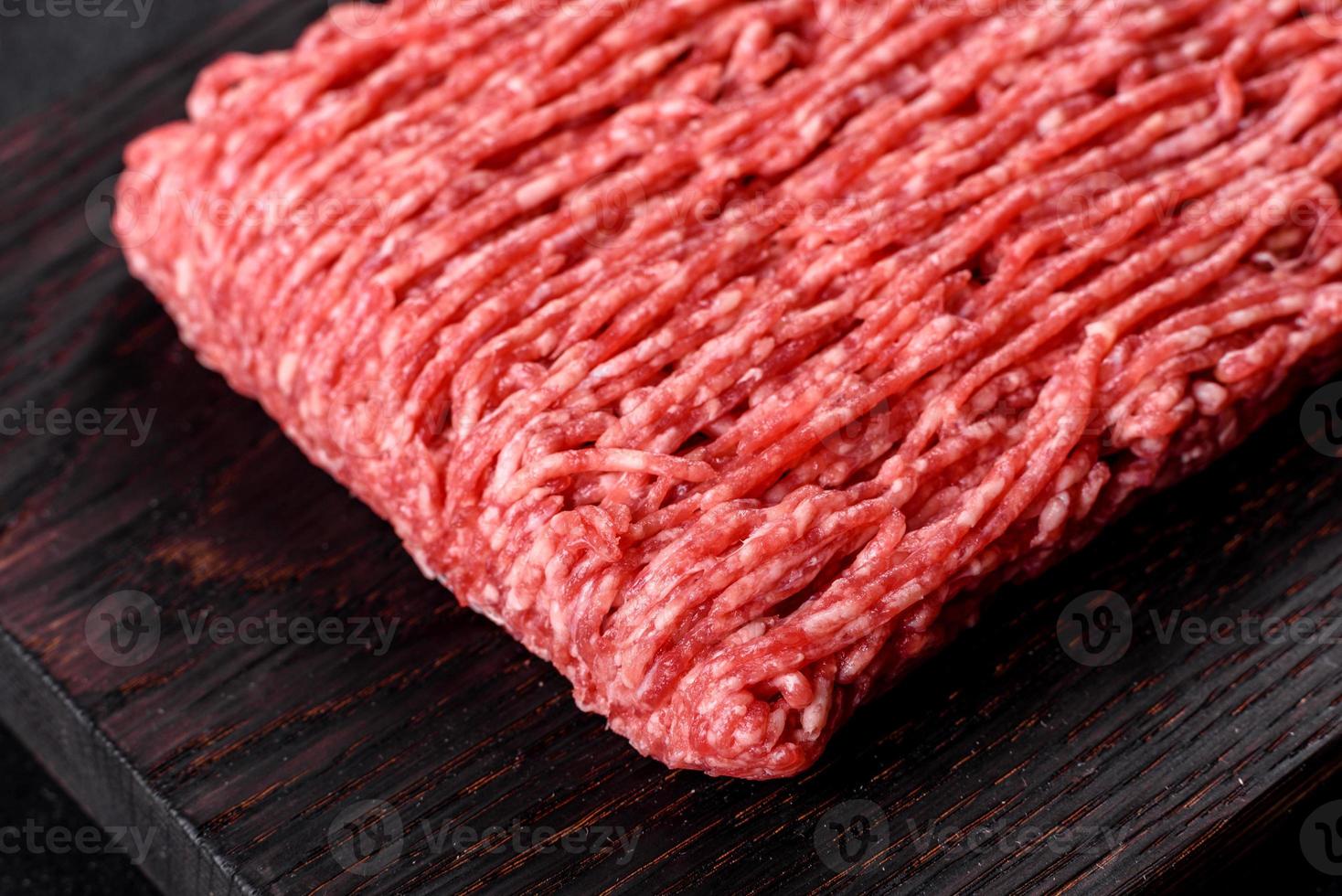 Fresh raw beef mince on a dark background photo