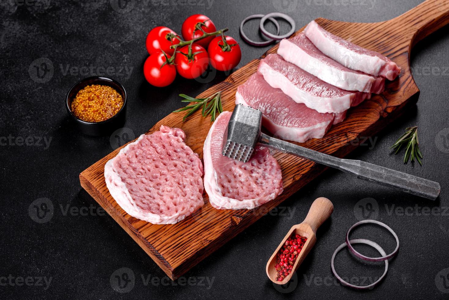A fresh raw piece of pork escalop cut into several parts photo