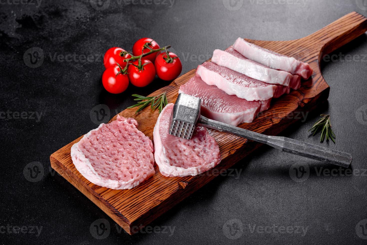 A fresh raw piece of pork escalop cut into several parts photo