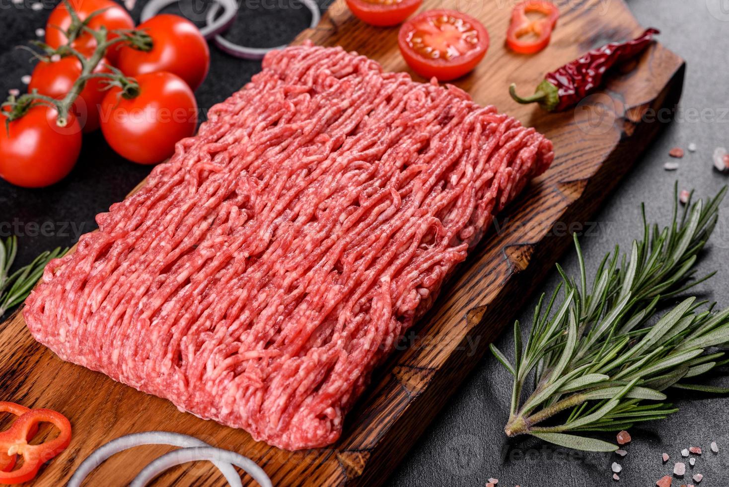 Fresh raw beef mince on a dark background photo