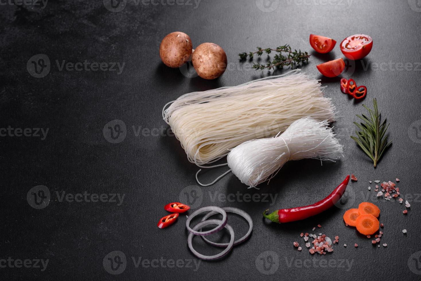 Tasty rice noodles with tomato, red pepper, mushrooms and seafood photo