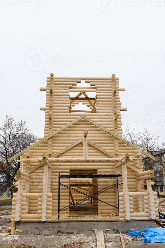 Construcción de una iglesia cristiana hecha de troncos de madera tratados. foto