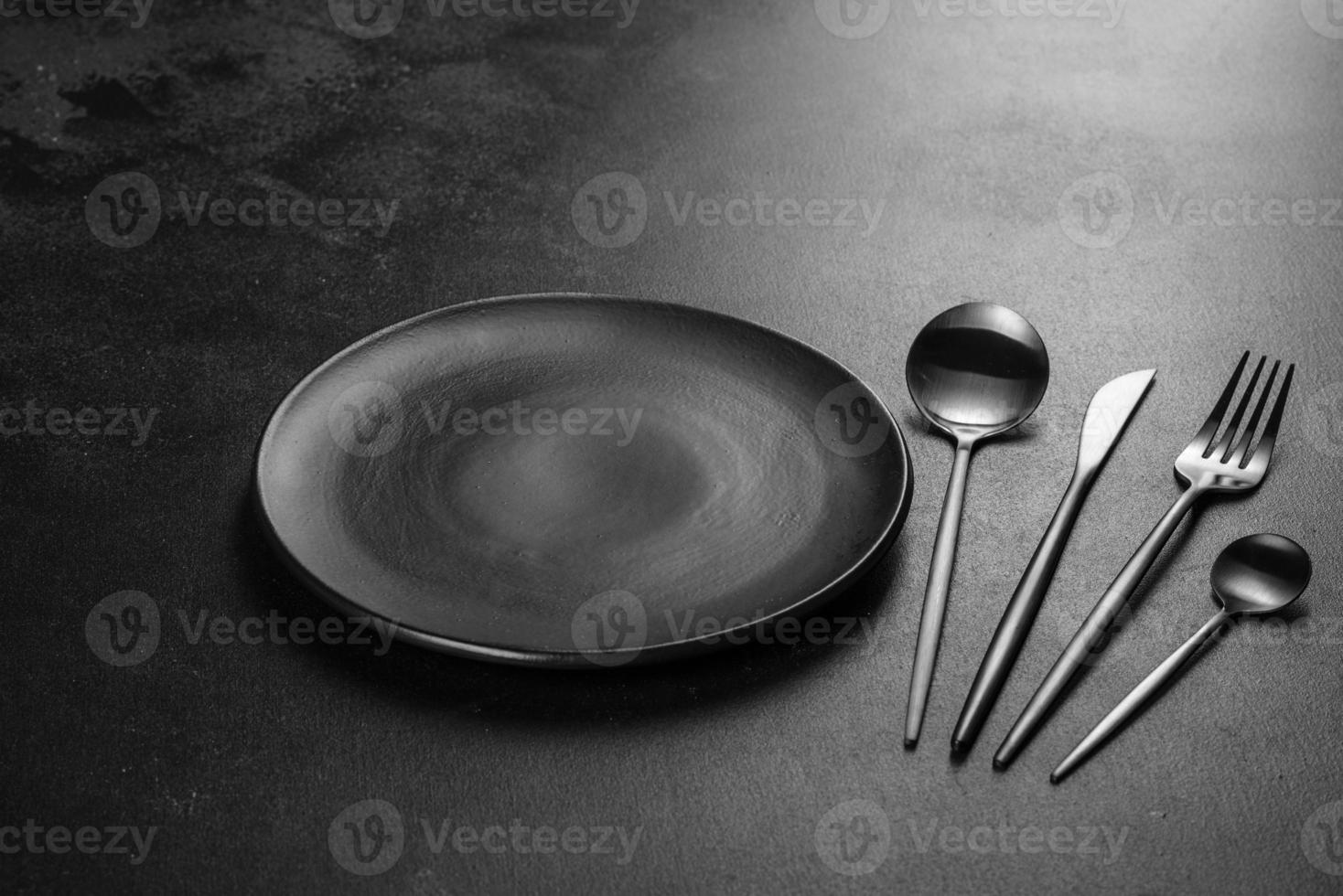 Black cutlery on a concrete dark table. Dining table photo