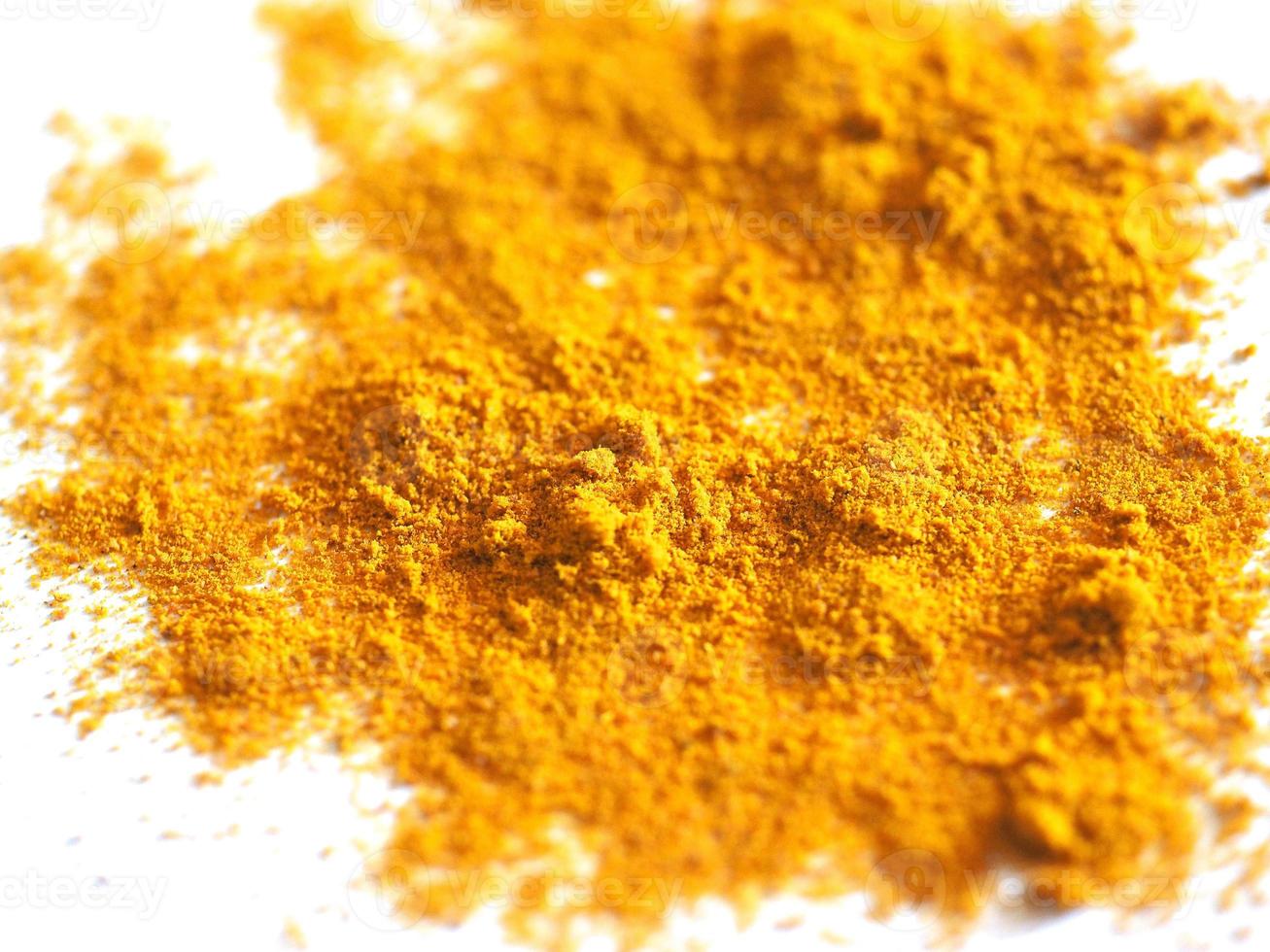 Curry powder blend over white photo