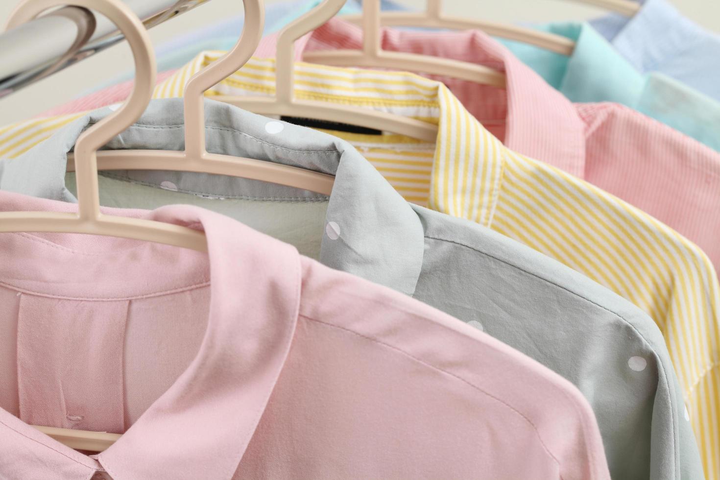 Pastel women shirts hanging on rack photo