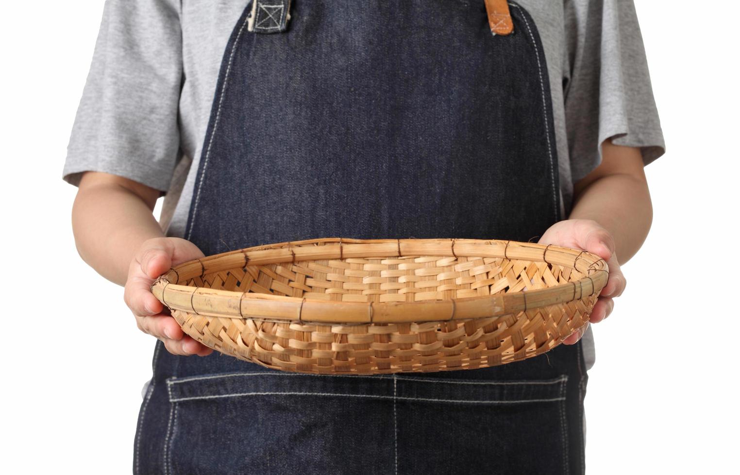 Chef holding wooden basket on white background photo