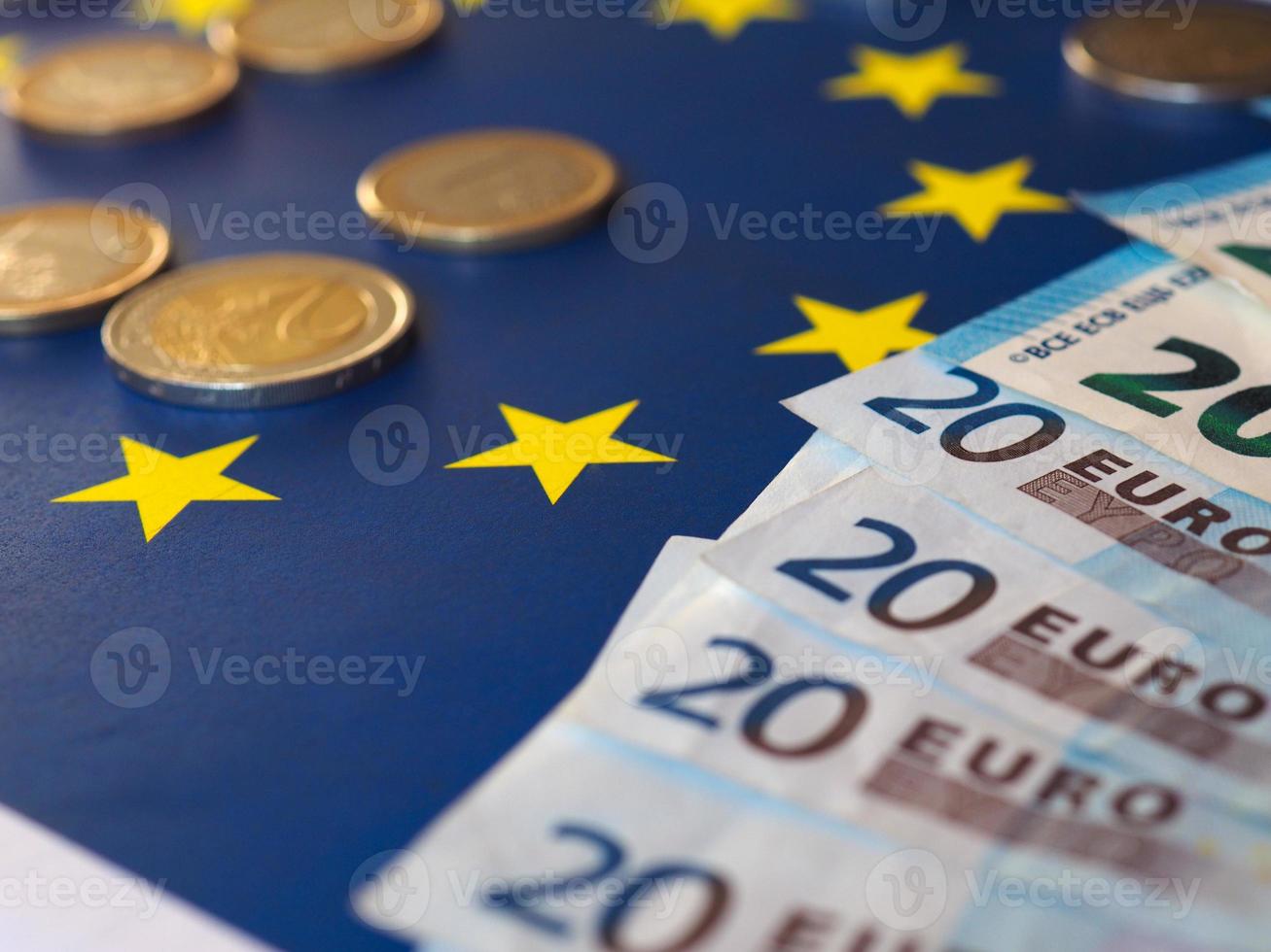 Euro notes and coins, European Union, over flag photo