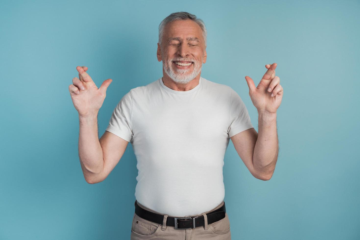 Portrait of a charming man with a beard raising his arms photo