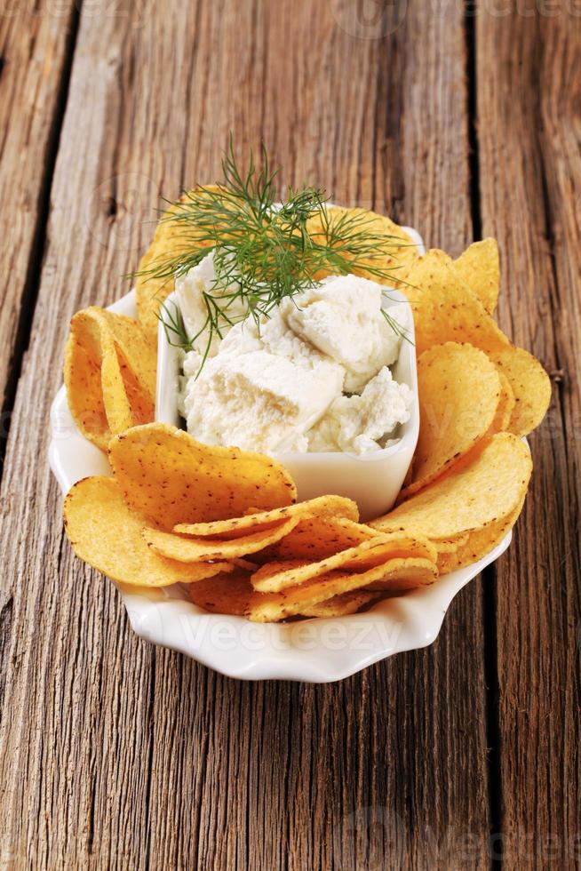 Corn chips and fresh cheese photo