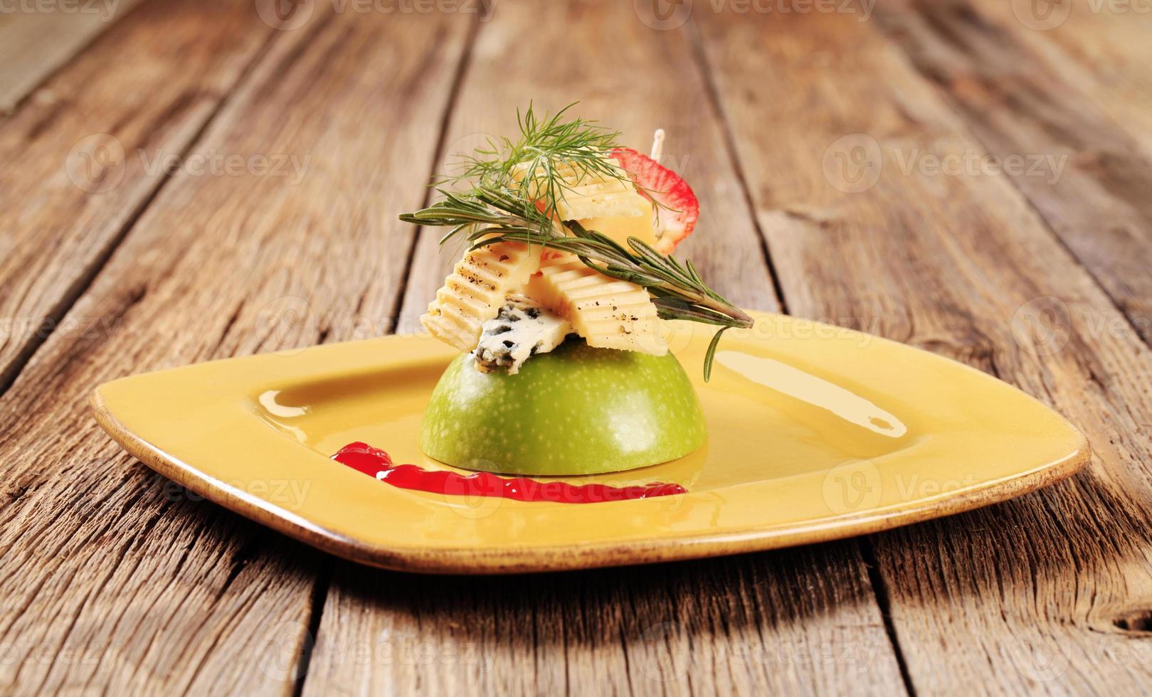 Various types of cheese on an apple photo