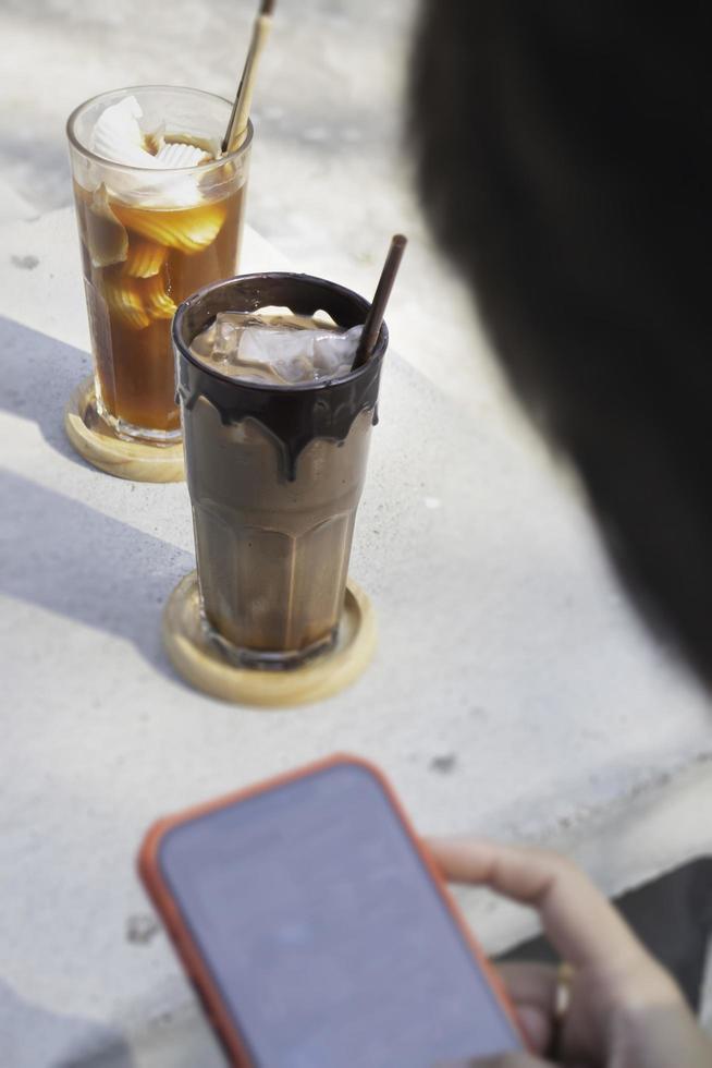 Glass of ice cubes and fresh coffee photo