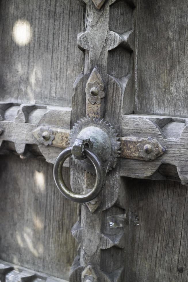 Old open wooden door with carved pattern photo
