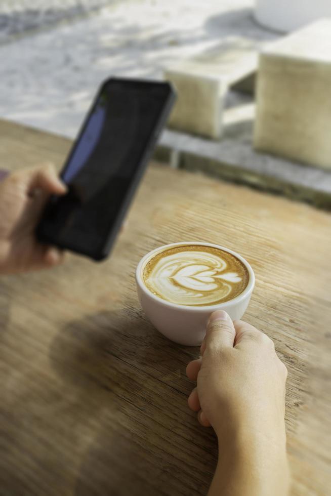 Morning coffee latte on wood desk work from home office photo