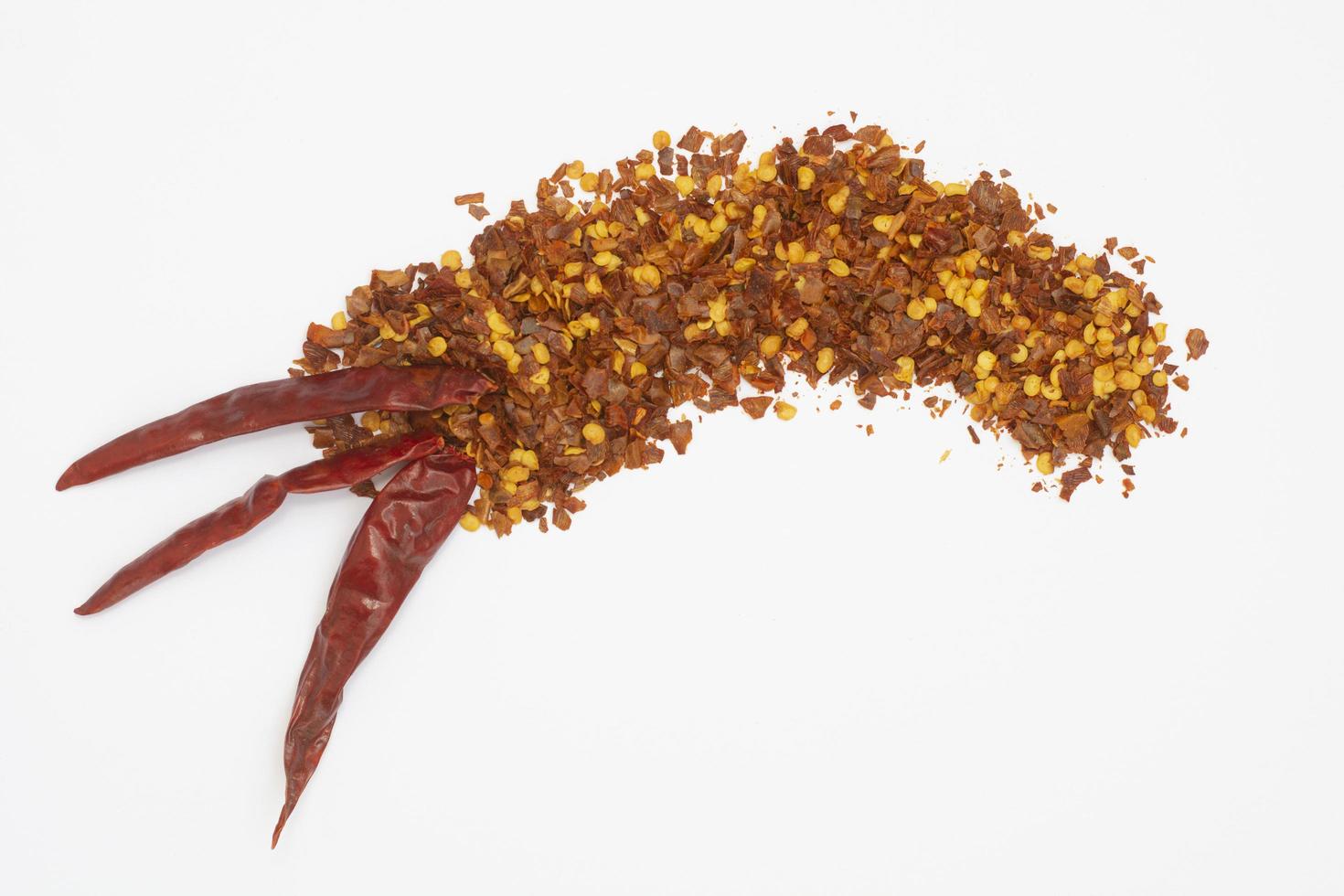 Dried red pepper flakes isolated on white, top view photo