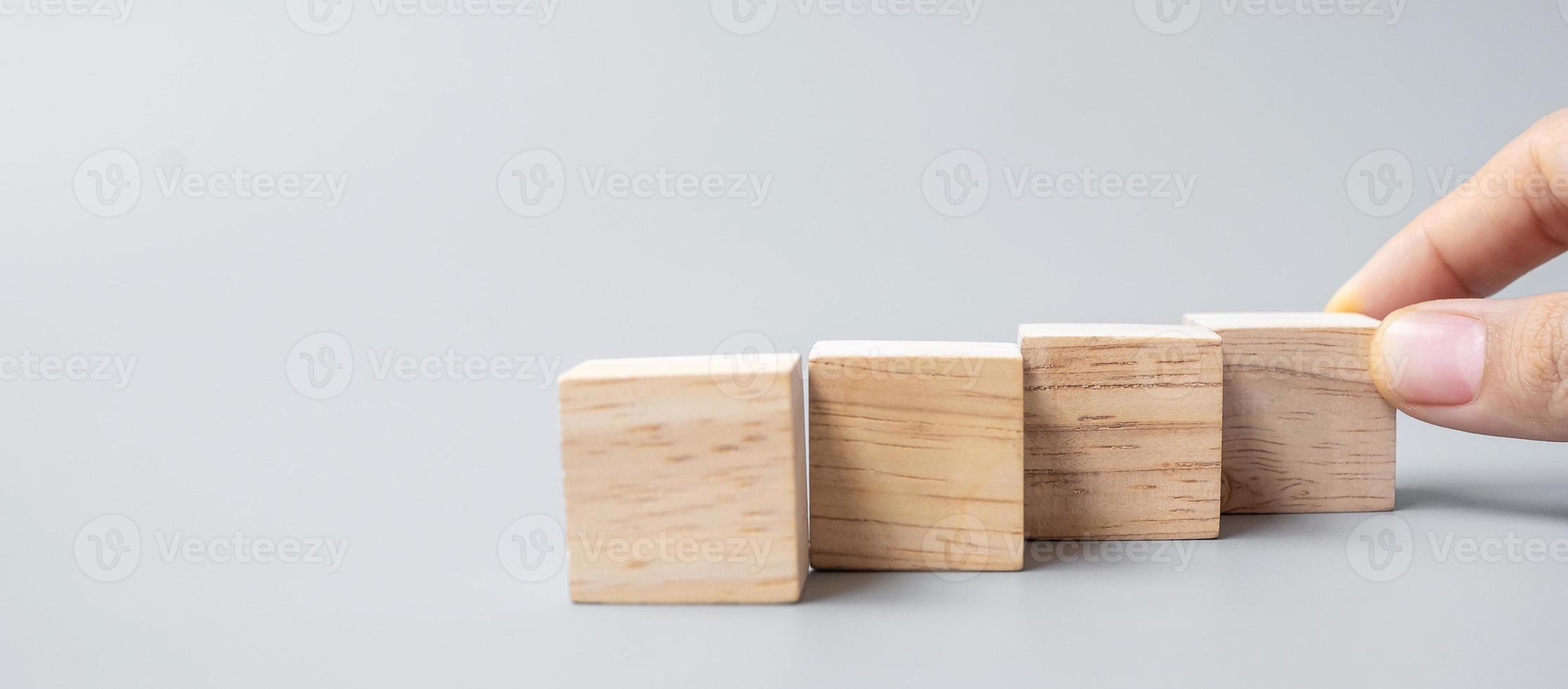 mano colocando o tirando de un bloque de madera foto